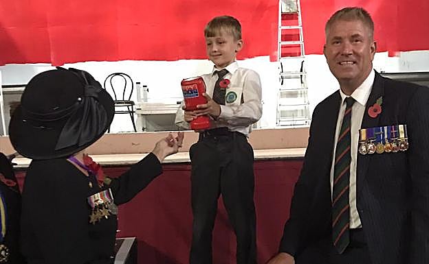 FUENGIROLA: Ruth Mokler Chairman of Mijas Costa and member Andy Nye receive donation from George, a pupil of British College in Benalmádena