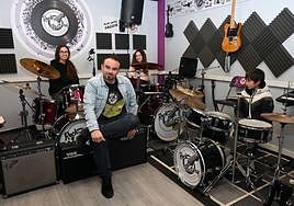 Rafael Reyes, director of Rock Factory, with three drumming students.