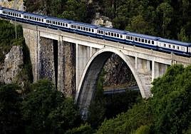 The elegant train crossing the railway bridge of Luarca in Asturias