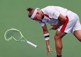 Davidovich throws his racquet to the ground in frustration.