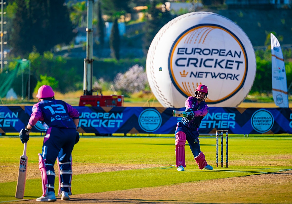 A CIYMS batsman aims for the boundary with a high shot.