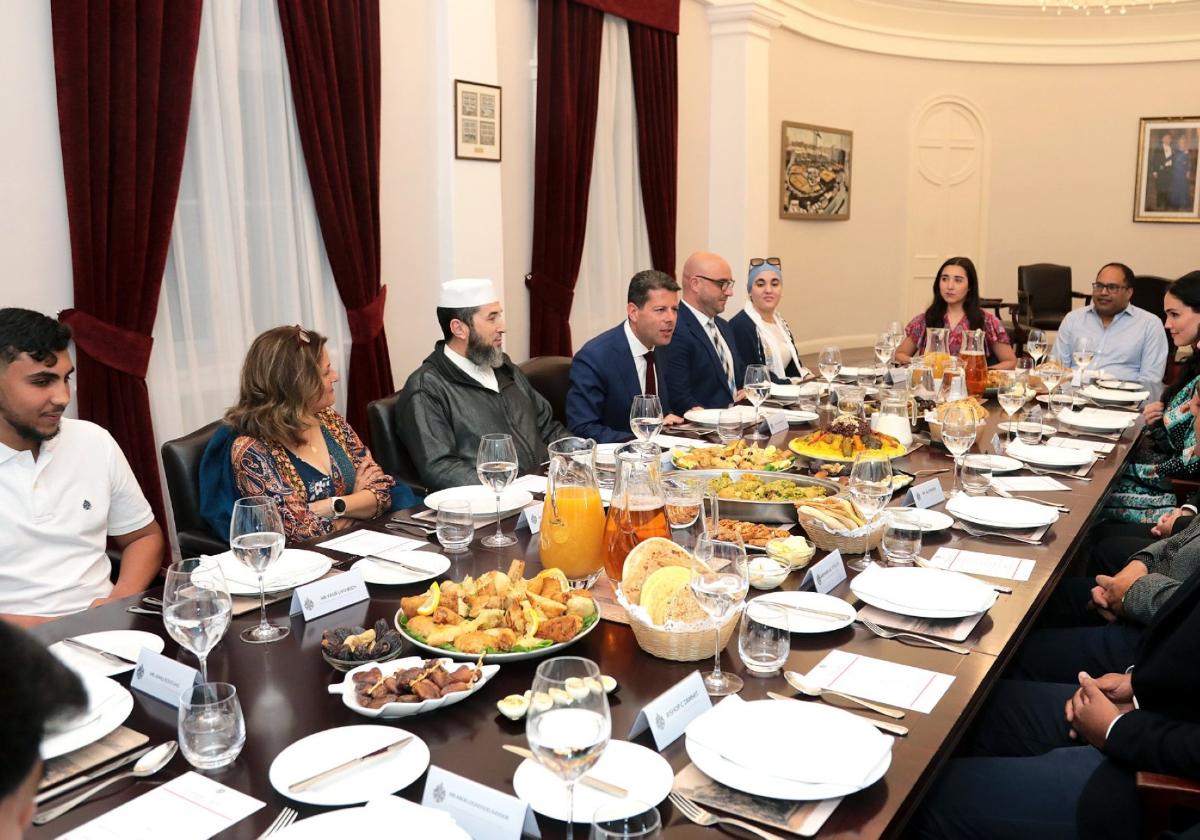 Fabian Picardo seated at the breakfast table with members of the community.