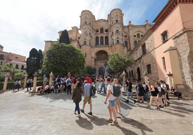 Tourists at the Plaza de los Naranjos, next to the cathedral in Malaga.