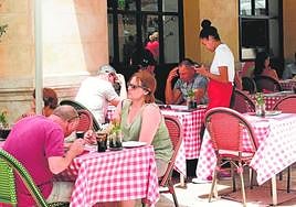 Tourists on the terrace of a hospitality establishment in Malaga city.