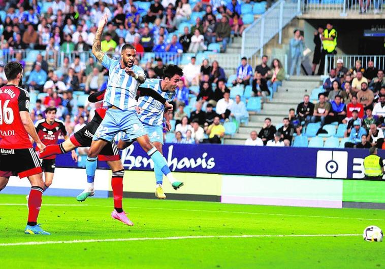 Alberto Escassi, background, gave Malaga an early lead with a powerful header.