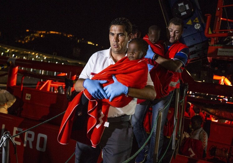 Volunteers of the organisation, rescuing children who arrived via small boats at Malaga port