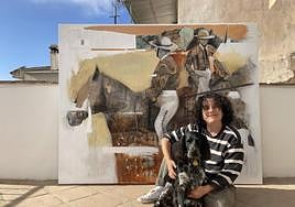 Victoria Dael with her dog and one of the paintings.