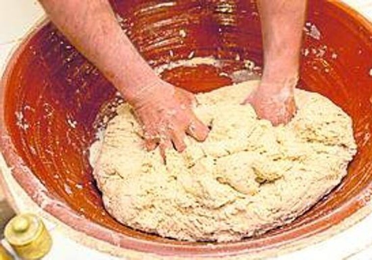 Kneading the dough to make the bread.