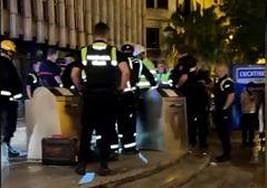 Police and firemen attempting to rescue trapped tourist.