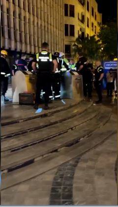 Police and firemen attempting to rescue trapped tourist.