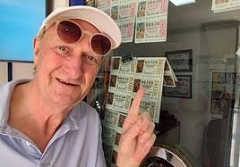 A buyer points out some of the first decimos up for sale in Malaga in the Christmas Lottery draw.