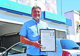 Adolfo Trigueros, in his workshop, with an old news article about his grandfather.