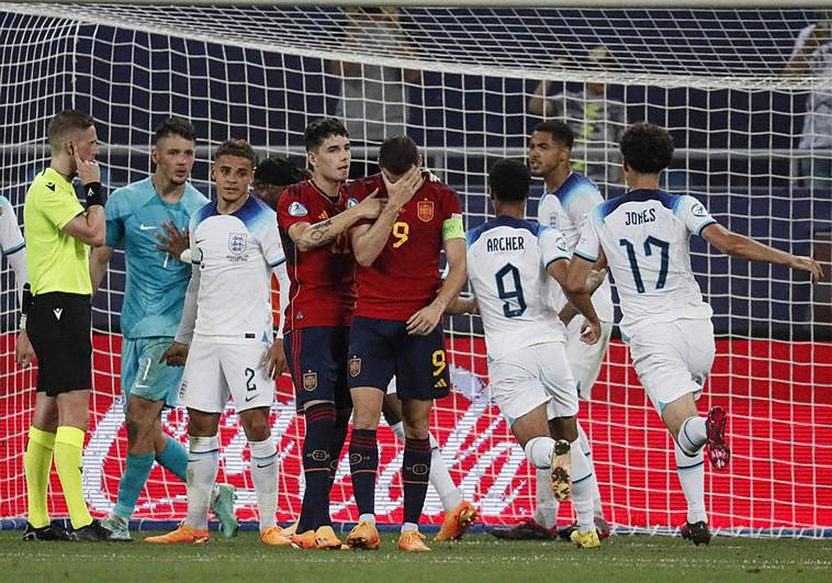 The England players celebrate after Abel Ruiz's penalty miss.