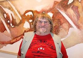 Alan Burden in Mijas with one of his paintings.