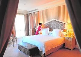 A worker makes up a room.