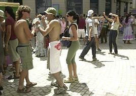 Two shirtless men in the city centre.