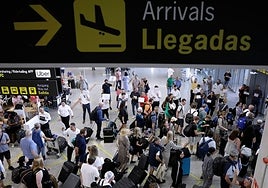 Tourists arriving at Malaga Airport in July.
