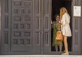 Ángeles Béjar (left), the mother of Luis Rubiales, talks to a family member in the Divina Pastora church in Motril (Granada).