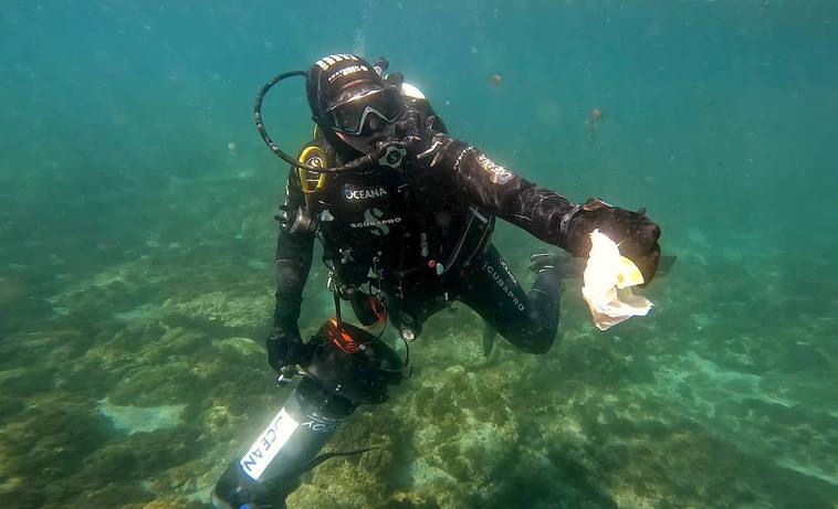 A diver removing rubbish from the sea floor.