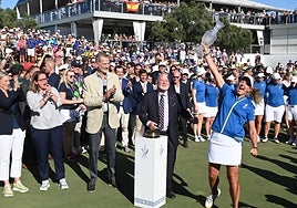 King Felipe VI of Spain (beige jacket) looks on as Team Europe captain Suzann Pettersen celebrates with the Solheim Cup.