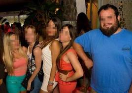 Pixelated photo of the priest with a group of women.