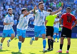 Striker Dioni celebrates giving Malaga the lead on Thursday.