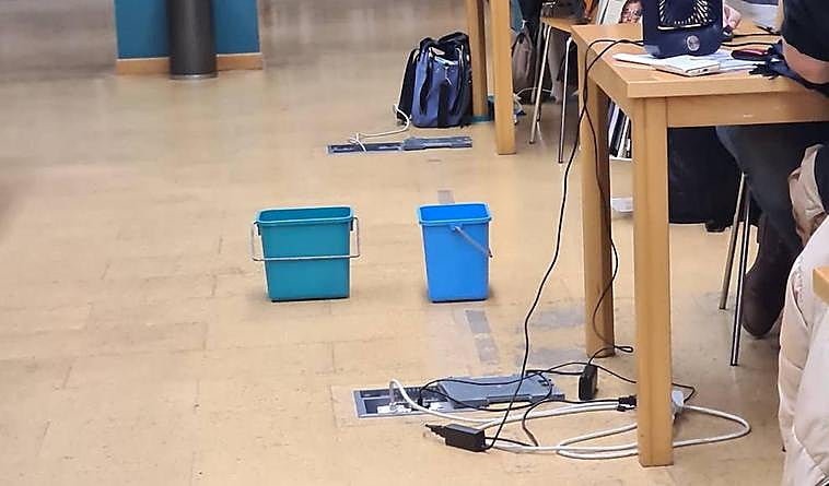 Buckets used to catch rain from leaking roof at Benalmádena library