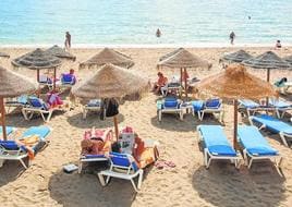 Tourists soak up the sun on a beach on the Costa del Sol.