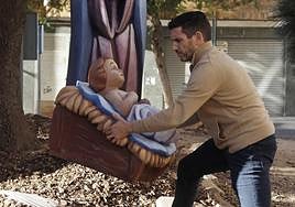 Then figure of the baby Jesus being placed back in the nativity scene.