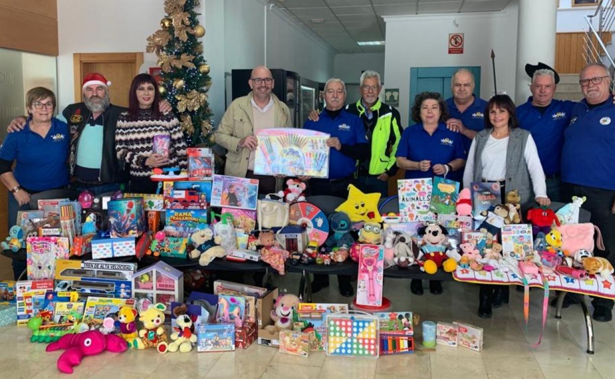 Members of the motorcycle club deliver the toys to the town hall. 
