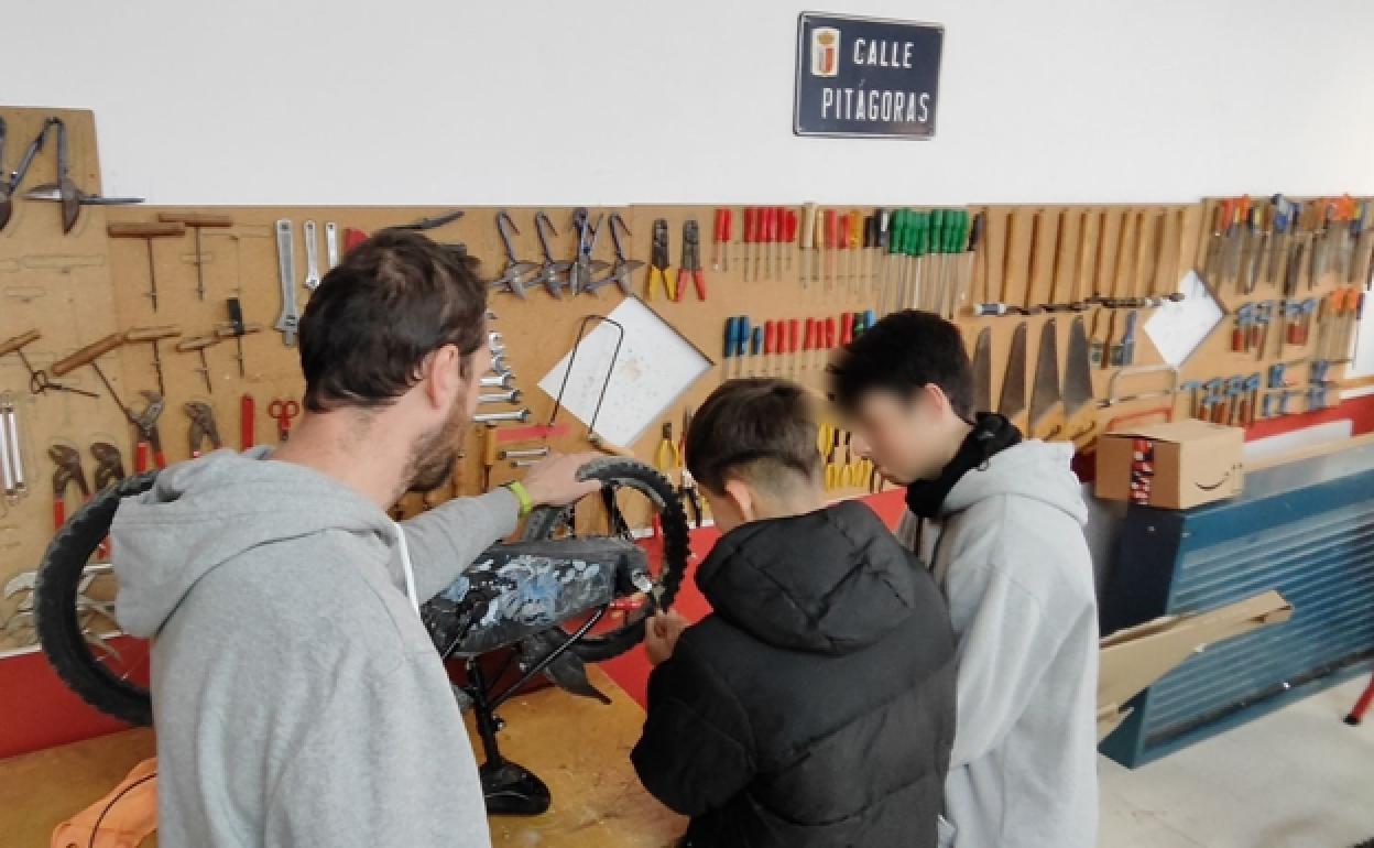 Students repair one of the donated bicycles. 