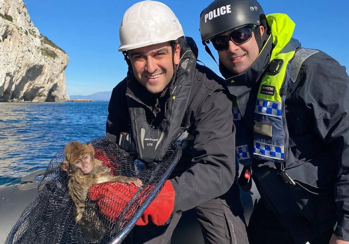 Officers with the rescued macaque.