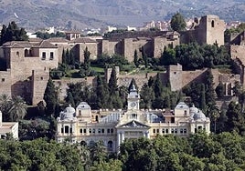 Façade of Malaga city hall with the Alcazaba in the background.