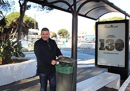 The councillor at one of the bus stops with a new litter bin.