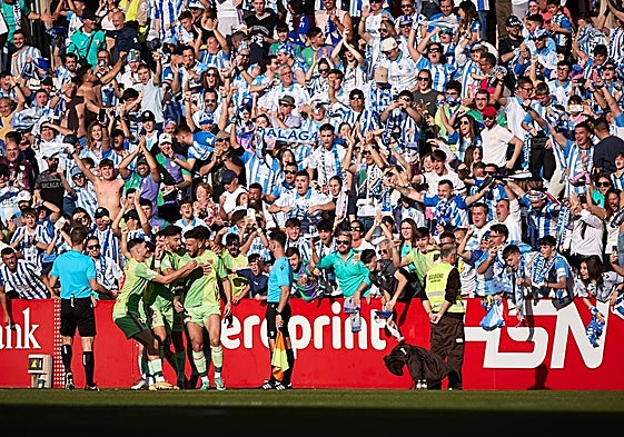 Malaga and their travelling fans celebrate Dioni's goal.