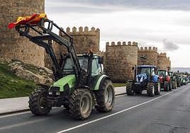 Tractors with protesting farmers make their way past the famous city walls of Ávila, central Spain, on Thursday.