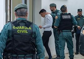 One of the suspects arrives at court in Barbate on Monday.