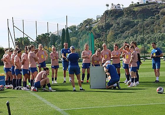 Sarina Wiegman, centre, and her staff talk tactics.