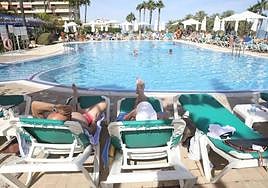 File image of holidaymakers enjoying the sun and swimming pool at a hotel on the Costa del Sol.