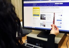 A woman searches for accommodation on Booking.com website.