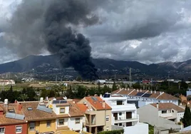 A large column of black smoke from the fire, visible from many areas of the town.