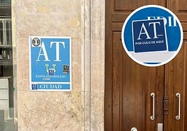 One of the plaques and stickers, on a building in the Carretería area.