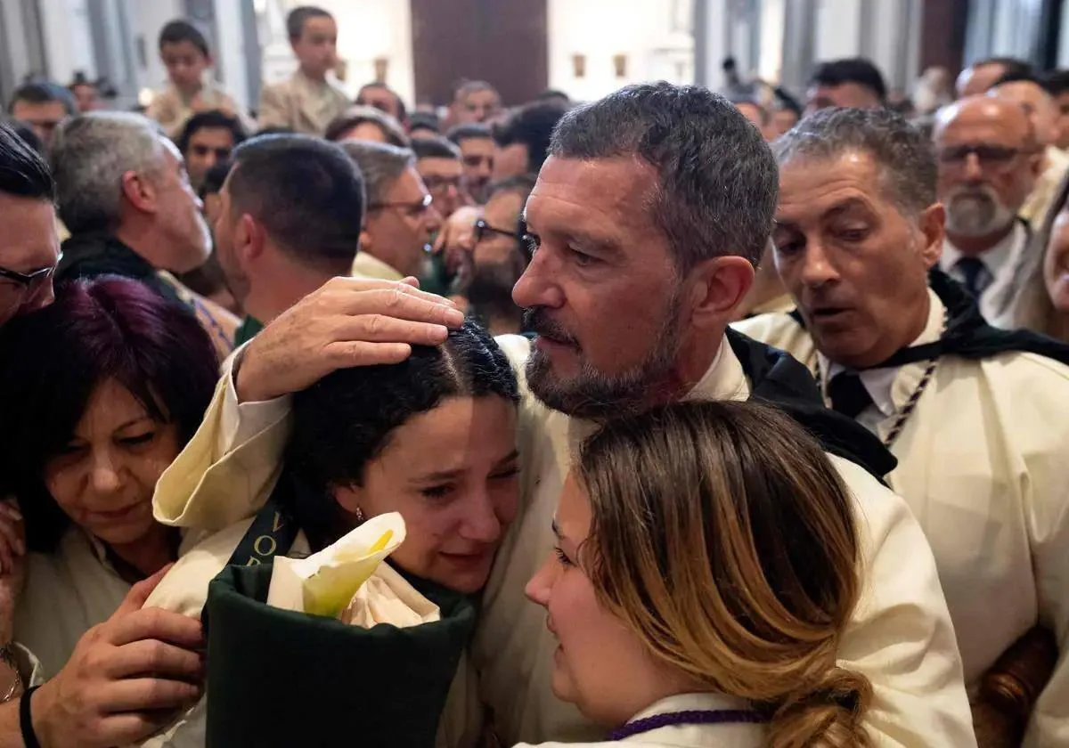 Malaga actor Antonio Banderas consoles other members of the brotherhood after the Easter procession was canceled by rain.