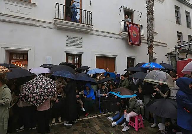 People sat waiting in the rain for the Semana Santa processions.
