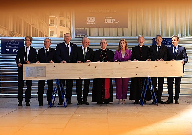 Authorities and technicians with the beam that has been lifted onto the roof