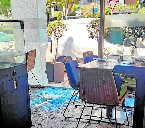 The windows of the restaurant after being hit by 15 bullets in March.