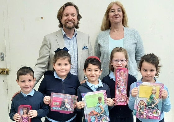 School children holding the disablity dolls.