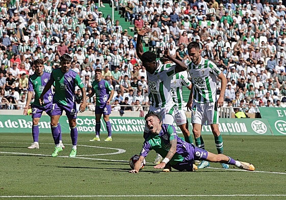 Malaga's Roberto goes down under a challenge during Sunday's match.