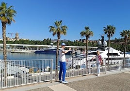 Tourists take photos at the top of Muelle Uno, in Malaga