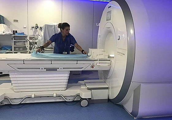A nurse prepares the tube for a new MRI scan.